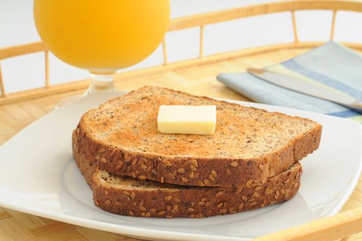 Whole grain toast served with butter.