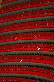 rows of red empty seats in a stadium