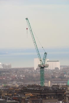 Crane being the most significant part of a landscape shows that this city is still growing. 