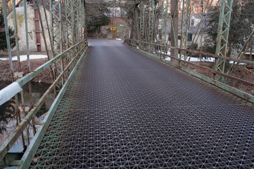 An old metal girder bridge and roadway.