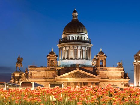 Evening kind on the Isaakievsky cathedral in St.-Petersburg and flowers before it