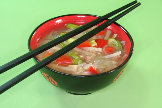 sour spicy Thai soup with glass noodles, chicken, bamboo shoots and peppers