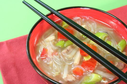 sour spicy Thai soup with glass noodles, chicken, bamboo shoots and peppers