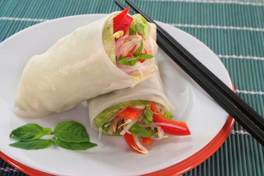 Lucky roll with lettuce, salmon, rice noodles, bell peppers and Thai basil
