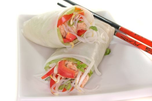 Lucky roll with lettuce, salmon, rice noodles, bell peppers and Thai basil