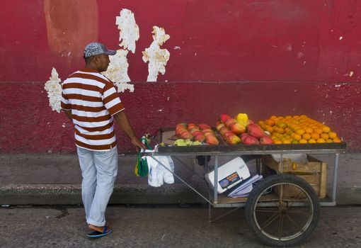 CARTAGENA DE INDIAS , COLOMBIA - DEC 24:Unidentified colombian man sell fruits in the street in Cartagena de Indias on December 24 2010