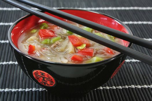 sour spicy Thai soup with glass noodles, chicken, bamboo shoots and peppers