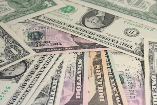 a pile of dollar bills in front of white background