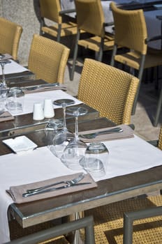 Covered table in the restaurant. Utensils for eating. Urban scene