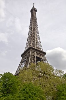 Eiffel Tower against the gray sky. Symbol of Paris.