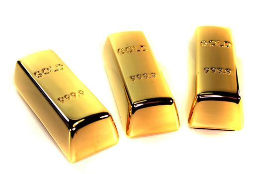 three large gold bars on a white background