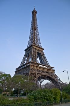 Eiffel Tower at afternoont. A symbol of Paris against the dark sky.