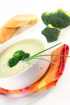 a cup of broccoli cream soup with fresh vegetables
