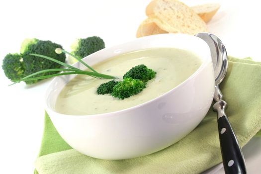 a cup of broccoli cream soup with fresh vegetables