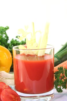 fresh vegetable juice with celery, fresh vegetables and parsley