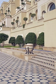 Luxury hotel built in the traditional Mughal style. Honey colored sandstone building with ornate tiled path. Agra, India