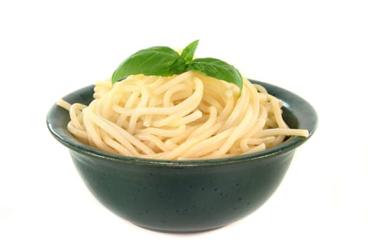 a bowl of spaghetti and fresh basil
