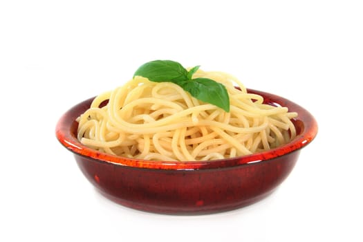 a bowl of spaghetti and fresh basil