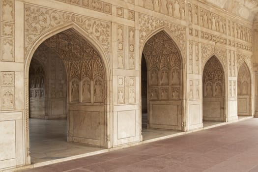 Detail of richly carved marble walls and arches decorating a Mughal Palace inside the Red Fort, Agra