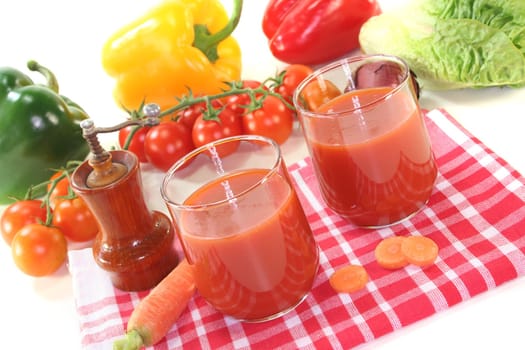 fresh vegetable juice with peppers, carrots and other fresh vegetables