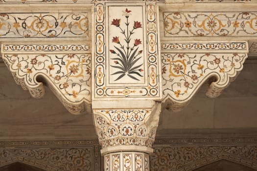 Detail of white marble pillar inlaid with semi previous stones in a Mughal Palace inside the Red Fort, Agra