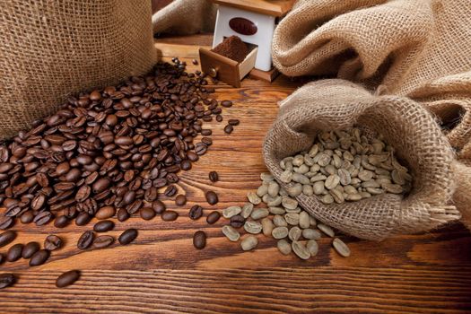 Studio photo of sack with scattered coffee and grinder