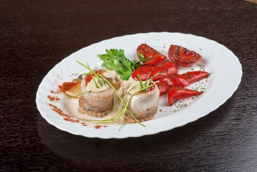 fillet of pikeperch stuffed with trout fish with baked pepper, tomato and leek