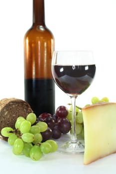 Red wine, cheese, grapes and bread on a white background
