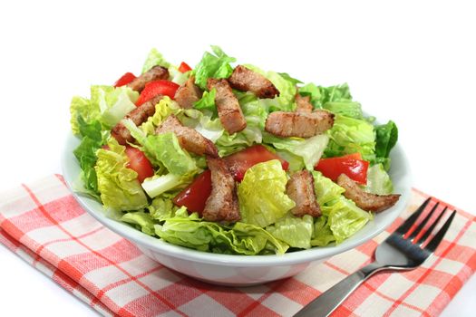 Salad with turkey strips on a white background