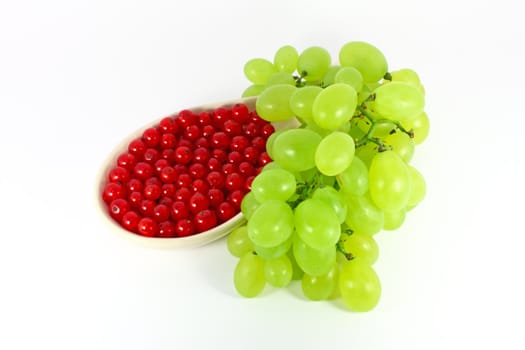 Grape and red currant isolated on white