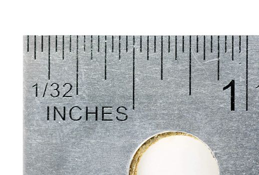 Give them one inch: industrial imperial units stainless steel ruler, macro shot showing one inch and the hole with cork underneath great details in the metal.