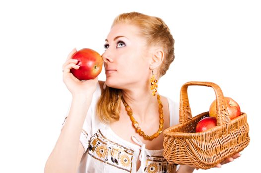 Redheaded woman smelling red apple over white