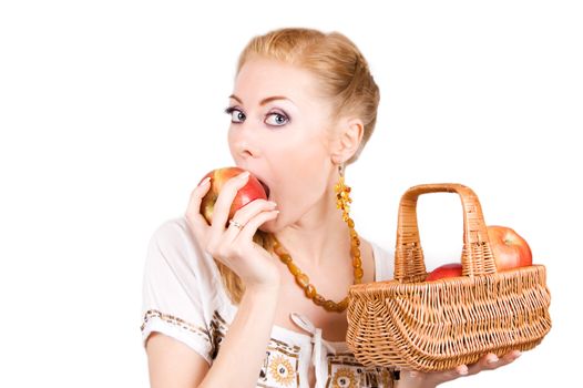 Redheaded woman with basket biting apple over white