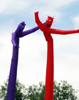 red and blue inflated human figure balloons for decoration