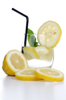 Glass of fresh cool drink with lime fruits isolated on white background.