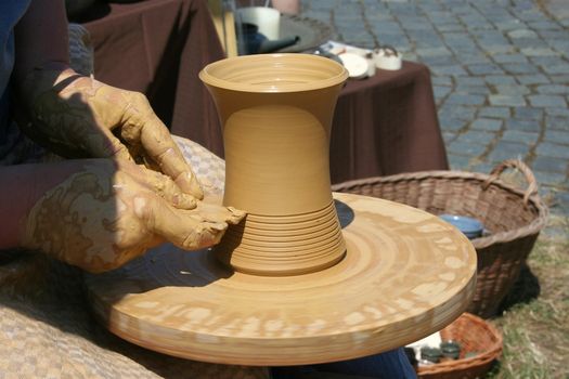a woman making pottery at the hub