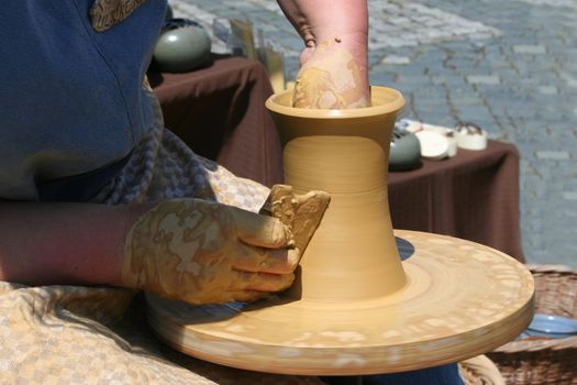 a woman making pottery at the hub