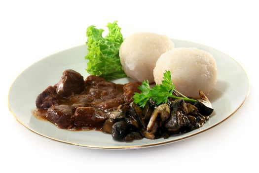 Venison goulash with dumplings and fresh mushrooms