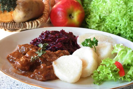 Venison goulash with dumplings and red cabbage