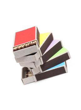 Stack of few open variegated matchboxes on white background