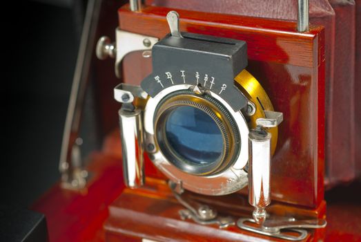 Close up of antique camera lens in mahogany and brass