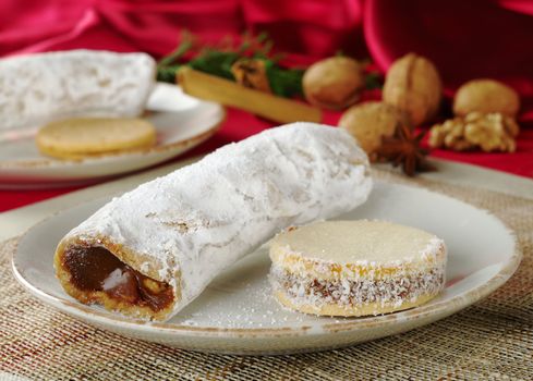 Peruvian cakes filled with a caramel-like cream called Manjar: the long one is called Guarguero, the round one is called Alfajor (Selective Focus, Focus on the front of the two cakes)