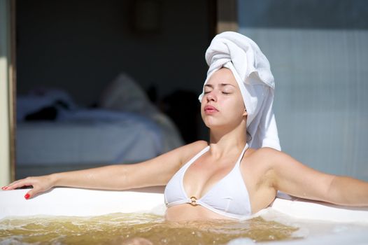 Woman relaxing in a jacuzzi in a resort in Porto Belo, Santa Catarina, Brazil