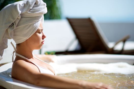 Woman relaxing in a jacuzzi in a resort in Porto Belo, Santa Catarina, Brazil