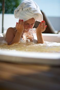 Woman relaxing in a jacuzzi in a resort in Porto Belo, Santa Catarina, Brazil