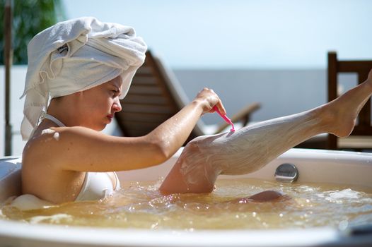 Woman relaxing in a jacuzzi in a resort in Porto Belo, Santa Catarina, Brazil