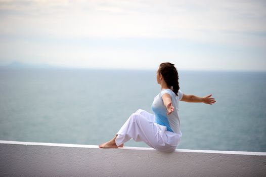 Woman relaxing on a wall in a resort in Porto Belo, Santa Catarina, Brazil