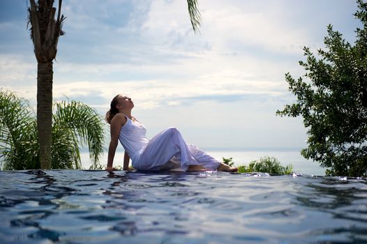 Woman relaxing in a paradise swimming pool in a resort in Porto Belo, Santa Catarina, Brazil