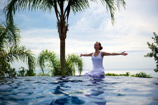 Woman relaxing in a paradise swimming pool in a resort in Porto Belo, Santa Catarina, Brazil