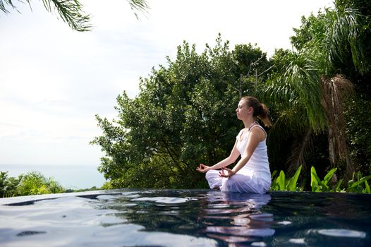 Woman relaxing in a paradise swimming pool in a resort in Porto Belo, Santa Catarina, Brazil